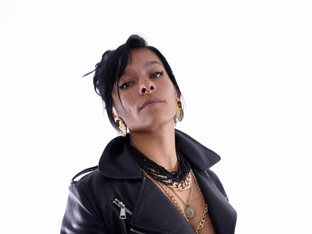 Flame-shaped design with bold, dark edges and a lighter center. Simple, symmetrical pattern. The flame's tip is slightly darker, creating a subtle gradient effect. Digital art style.