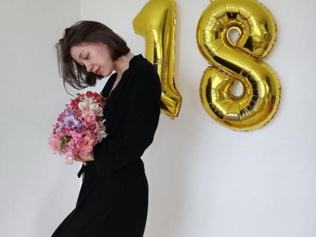 Three bold, stylized flags in a row. Top flag: gold with black and white. Middle flag: black with red and white. Bottom flag: pink with red and white. Minimalist design.