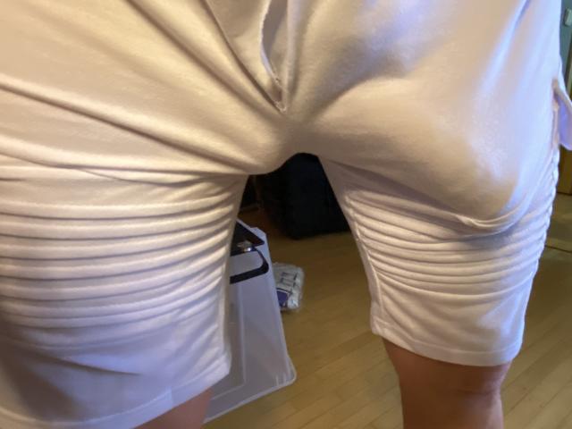 OndraSekCZech's white, ruched, tight shorts are highlighting their butt and crotch, with visible creases and a slight bulge. Their legs are slightly apart, showing a bit of thigh.