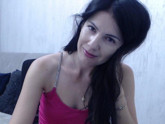 Floral, flat-style coat of arms with bold, white letter "V" in the center. Soft pink and white colors dominate. Simple, geometric shapes. Minimalist design. LanyJolene not present.