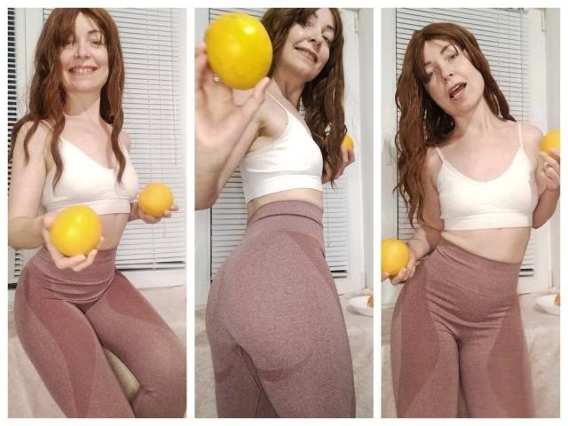 DianaFetishX-hot with red hair, white sports bra, and pink high-waisted leggings, holding yellow lemons, showing her ass in three different poses.