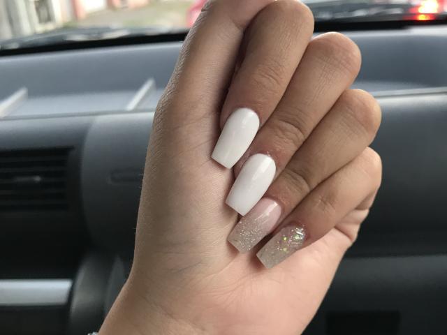 AlexaLip's hand with white, nude, and glittery pink nails, slightly curled fingers, showing off her glossy, polished, sexy nails in a car's interior.