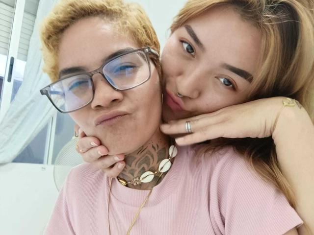 SeleneAna with blonde hair and glasses, tattooed neck, pink shirt, and necklace. SeleneAna with brown hair, nose ring, and ring, leaning on her neck, smiling.