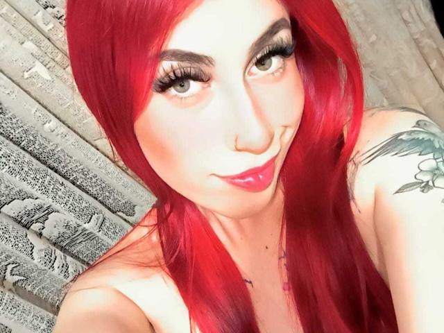 Red and white flag with a black and white emblem in the top left corner, and a large red emblem in the bottom right. Simple, bold colors and shapes.