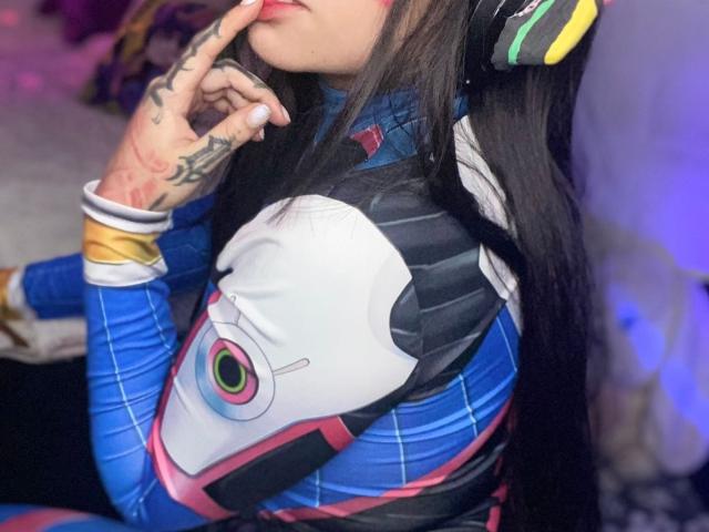 A minimalist digital illustration of a stylized, ornate letter "L" in soft pink and blue. The letter has a subtle, almost translucent effect with smooth, rounded edges.