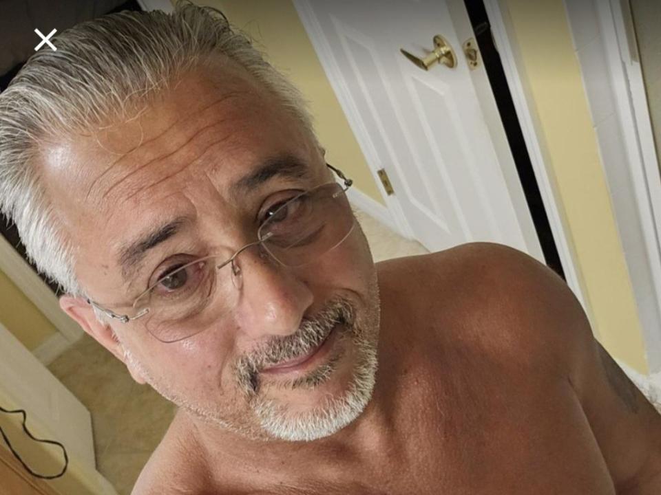 A digital illustration with a minimalist style. Central white letter "E" with a small black dot inside. Soft pink gradient background. FlirtyOneForU's presence implied but not visible. Simple, clean design.