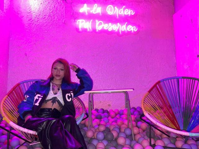 Close-up of a red and black Asian-style emblem with vertical lines and geometric patterns. Centered, bold design. HaslyHamipton's name is not visible. Simple, elegant composition.