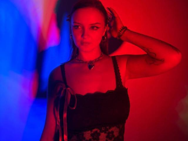 Red and blue Soviet-style coat of arms with a bold red "R" in the center. Simple, symmetrical design with flat colors. Clean lines and minimalistic.