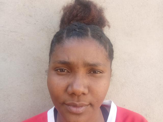 Flat, minimalist design with a large, solid red and pink emblem in the center. Simple, bold colors, no gradients or textures. The emblem is slightly raised, creating a subtle shadow.