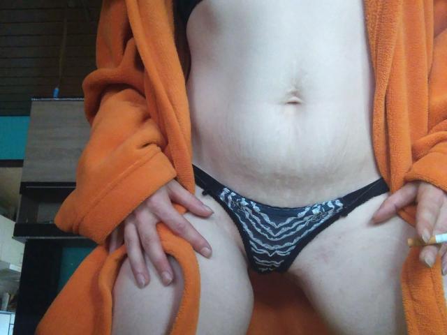 Jennylove-hot's pale, slightly chubby belly with a small navel, wearing black and white zebra-patterned panties, and an orange robe, hands on her thighs, exposing her pussy.