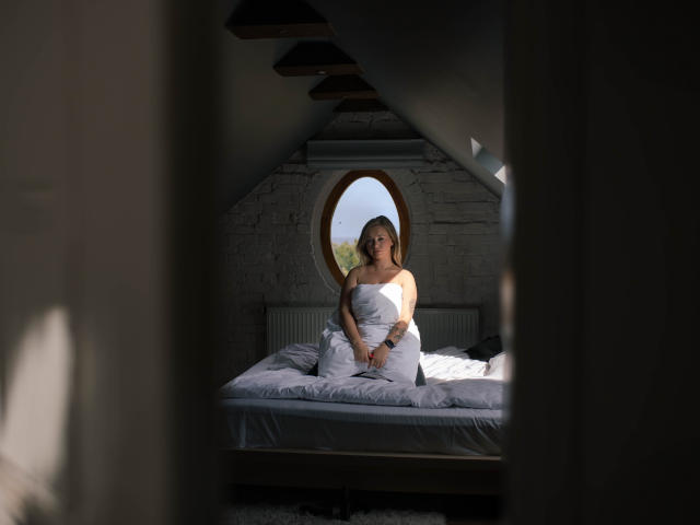 Digital illustration of five overlapping, stylized coat of arms. Each coat features a white, vertical, vertical bar in varying positions. Colors are muted with a focus on white and pink.