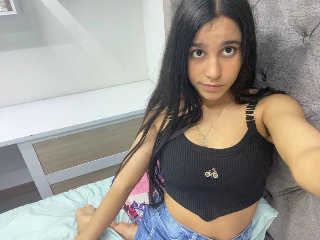 Digital art of a minimalist style featuring a large, flat, white letter "A" with subtle pink and red gradients. Simple, clean lines and flat colors dominate the composition.