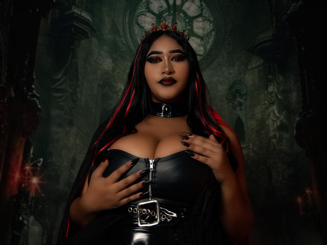 MelisaJackie with big tits, black leather corset, metal choker, red-black hair, crown, dark makeup, black nails, hands on chest, dark goth-style, moody red-green lighting.