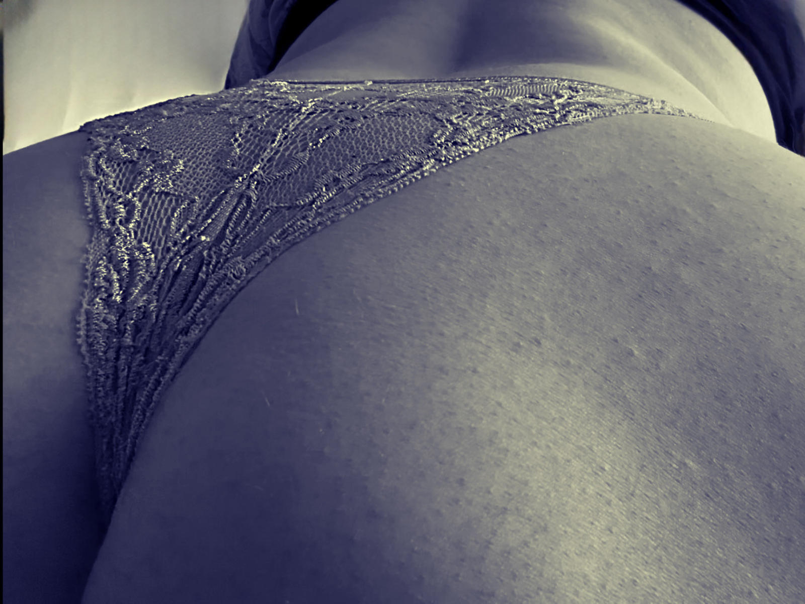 PrettyKimberlyS's ass in lacy purple panties, showing detailed lace pattern and smooth skin, taken from a low angle.