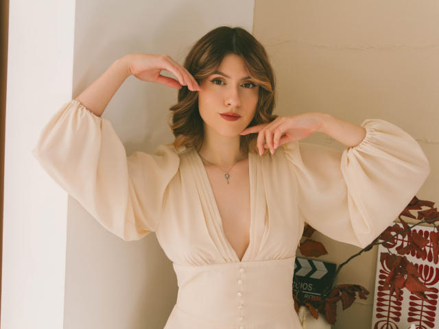 Close-up of a flat, 3D-style illustration with a large, red emblem in the center. The emblem has a bold, black letter "L" in the bottom right. Colors are muted.