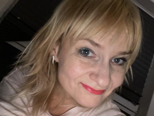 Stylized coat of arms with bold, flat colors. Centered design features a large, red, vertical rectangle with a smaller, black, vertical rectangle above it. Simple, geometric shapes.