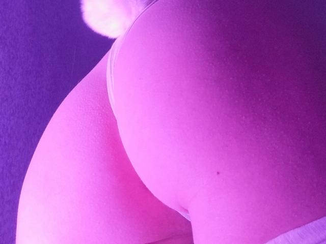 ExcitedBlizzard's pink-tinged ass, highlighted by a fluffy white tail, fills the frame with a soft, glowing texture. The image focuses on their round, plump buttocks.
