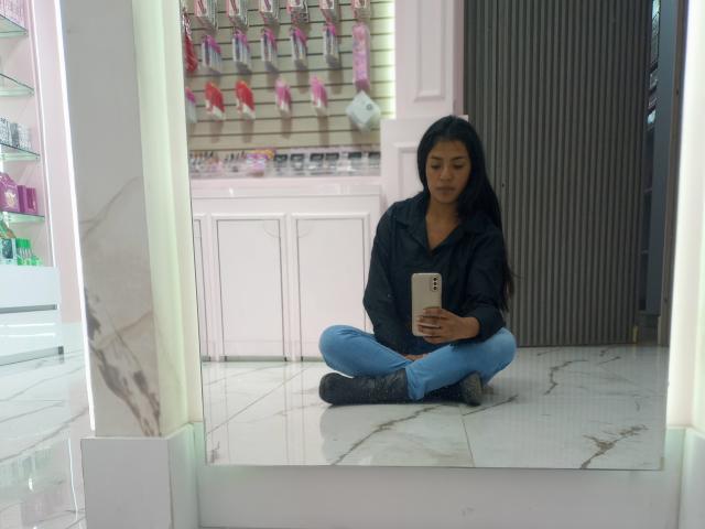 Digital illustration of a large, upright, red-and-white Russian double-headed eagle with bold, solid colors and clean lines. The eagle's wings are partially open, and it stands centered.