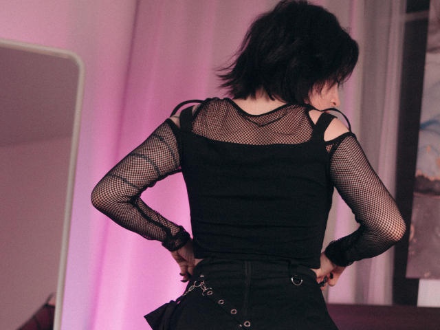 A digital illustration of a modern-style coat of arms with a bold, geometric design. The central emblem features a red and white pattern, with a small, dark figure in the background.