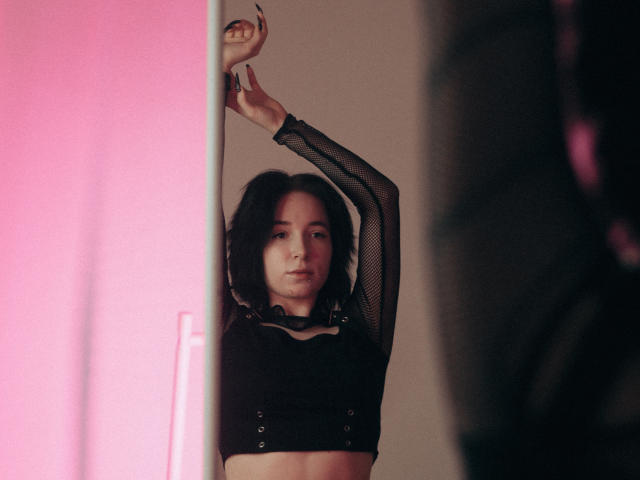 Flat, minimalist design of a coat of arms with a bold, red center and black edges. Simple, geometric shapes. No textures or gradients. Solid colors and clean lines.