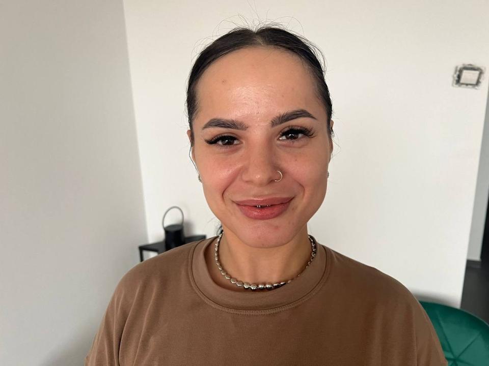 A close-up of a Chinese-style paper lantern. The lantern has a red and black design with a small black character in the center. Soft, subtle lighting.