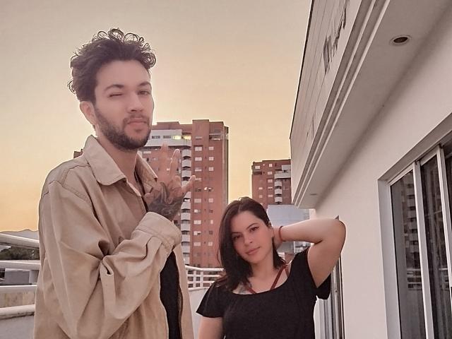 HottersTeam, dude with curly hair, beard, tattoo on hand, beige shirt, winking, showing middle finger. HottersTeam, brunette, black shirt, hand in hair, looking at camera.