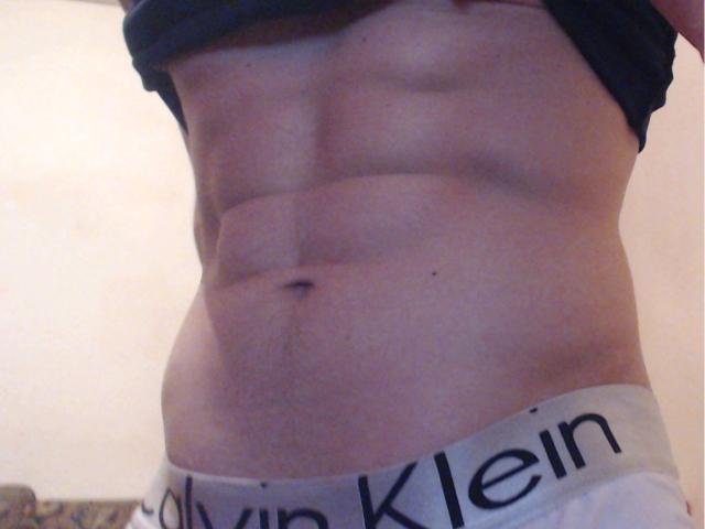 Cristiano's toned abs, visible six-pack, and a slight tan line with Calvin Klein underwear, lower waist, raised shirt, no face, indoors, soft lighting.