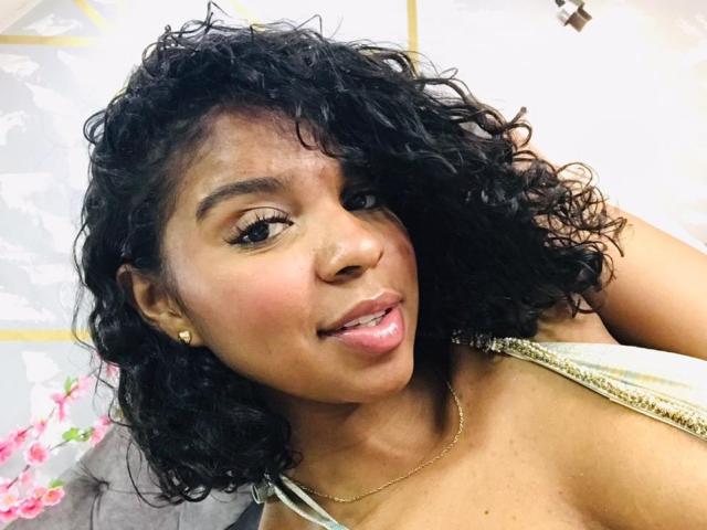 Stylized, bold lettering in a dark, flat color style. Letters are large, with thick, black outlines and soft, pinkish fill. Text is centered, slightly overlapping. Minimalistic, modern design.