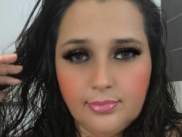 Close-up of a flat, stylized, and minimalistic design featuring multiple overlapping, slightly transparent red and pink shapes with white edges. Simple, geometric composition. No texture or detailed elements.