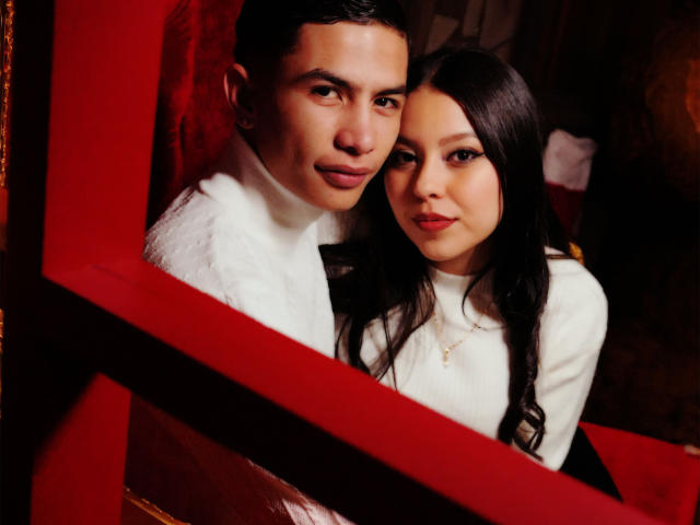 KylieAndJustin, Asian couple, standing, red frame, white turtlenecks, Kylie's black hair, Justin's short hair, Kylie's tits slightly visible, Justin's ass not visible, both looking at camera.