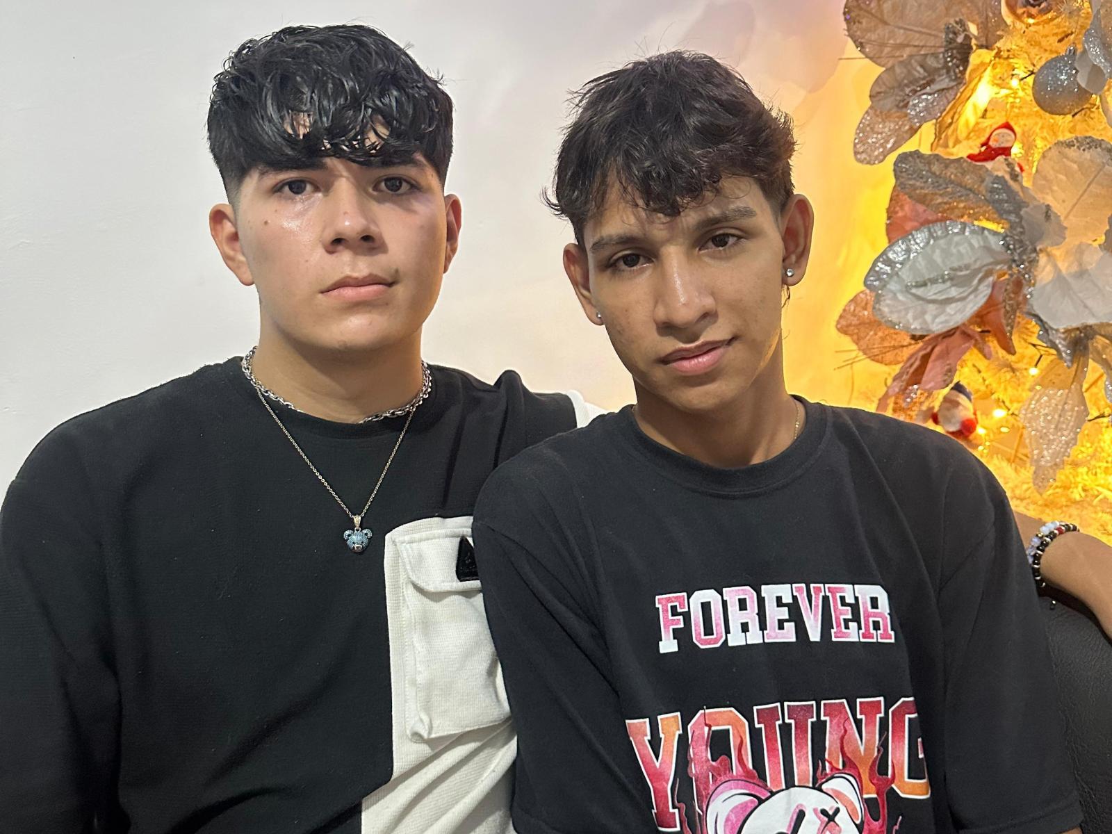 Digital art of a flat, stylized coat of arms with a central white shield and four smaller red, white, and black flags in each corner. Simple, bold colors.