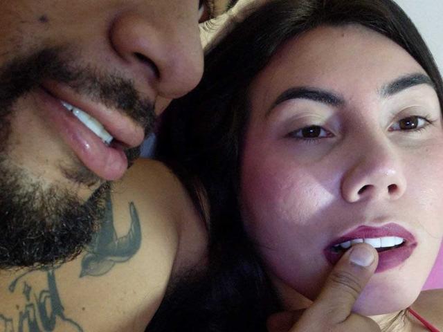 MorboErotico69 with a beard, tongue out, and tattoo on shoulder, next to MorboErotico69 with dark hair, brown eyes, and finger in mouth. She has pinkish cheeks.