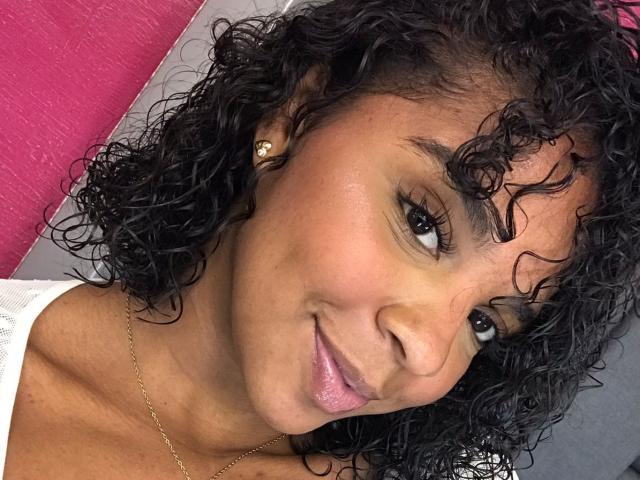 Graphic illustration of a bold, red and black emblem with a simplified, stylized design. Centered emblem with sharp edges and minimalistic details. Subtle gradient from red to black.