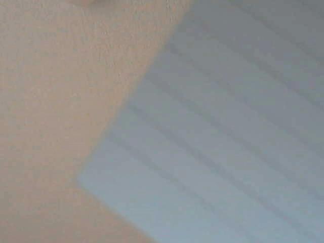 A beige wall with a blue, horizontally-striped section, creating a contrasting pattern. FlipFlops-hot's ass is partially visible on the left, with the striped section on the right.