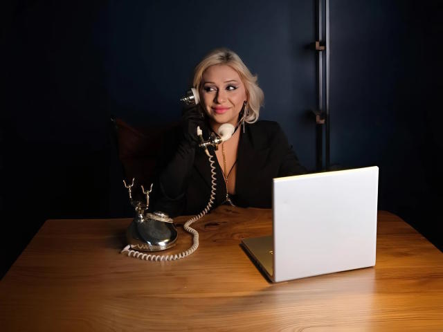 Minimalist digital art of a coat of arms with a central red and white shield, flanked by smaller blue and white shields. Clean lines, simple colors, and symmetrical layout.