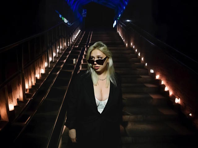 A minimalist digital illustration of a coat of arms with a central red and white emblem, flanked by smaller red and white symbols. Simple, clean lines and flat colors.