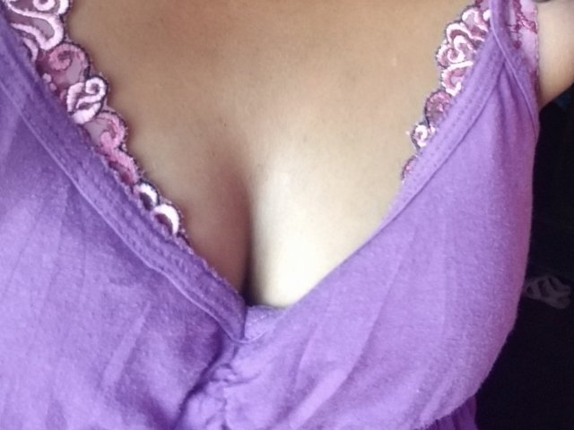 Mouniah's purple tank top with pink lace trim, showing her big, cleavage-filled tits. Her skin is light brown, and the focus is on her chest.