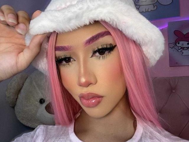 AlissLovely with pink hair, white fluffy hat, pink eyebrows, long eyelashes, glossy pink lips, holding hat, wearing white top, cute, soft pink glow.