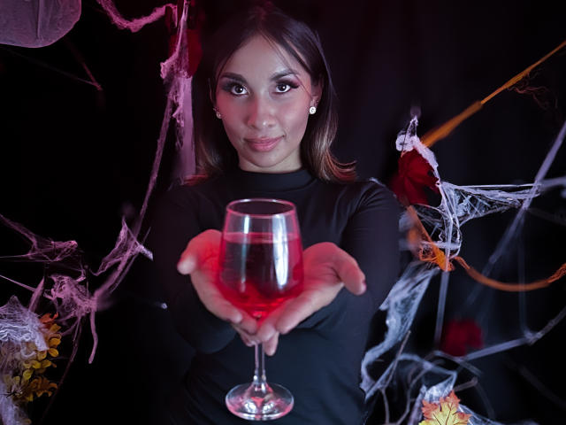 A digital illustration with a minimalist style. Central red and white emblem with a small red emblem below. LexyHottie's figure is not visible. Bold colors, clean lines.