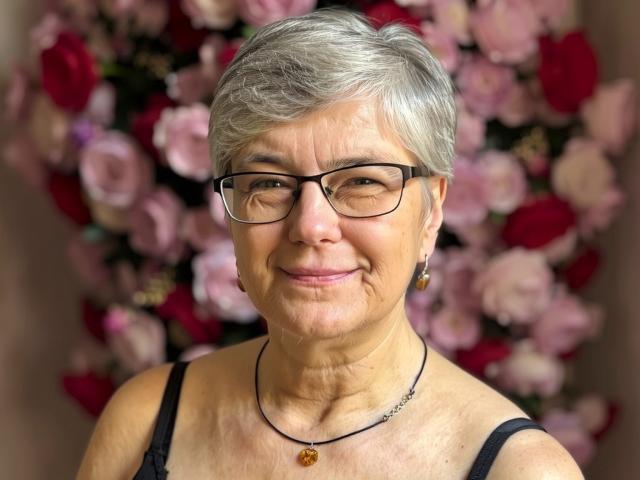 Sensualiiris in a minimalist, modern art style. Simple, bold shapes. Large, flat colors. Centered, white, abstract pattern in upper middle. Background is plain. Slight shadow on right.