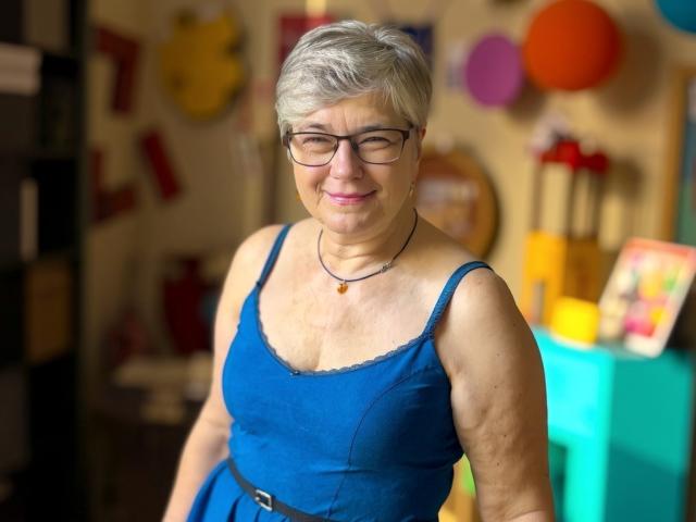 Digital illustration of five stylized, partially transparent, colored flags with a central, darker flag. Flags have soft, gradient colors and subtle shadows. Simple, modern aesthetic. Minimalistic design.