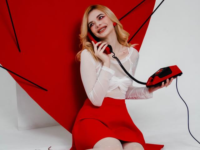 AdeleClifford with blonde hair, red skirt, white blouse, holding red phone, smiling, red earrings, sitting, red background, looking cute, holding phone cord, sexy, beautiful.