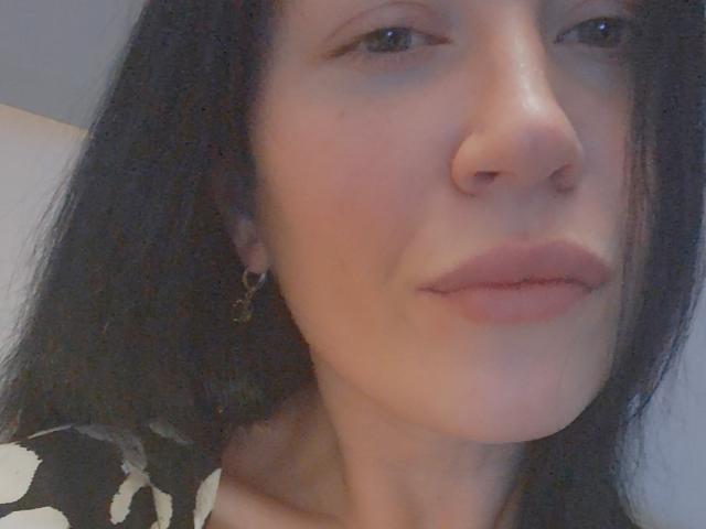 Close-up of a white coat of arms with a red center, flanked by smaller red and white sections. Simple, symmetrical design. Coat of arms is centered, dominant in image.