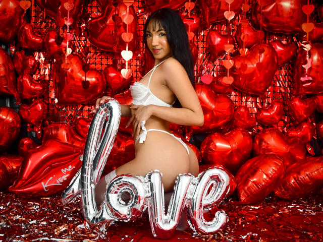 Digital art of a stylized red and black banner with white, ornate design elements in the center. Background is blurred, focusing on the banner's intricate patterns and bold colors.