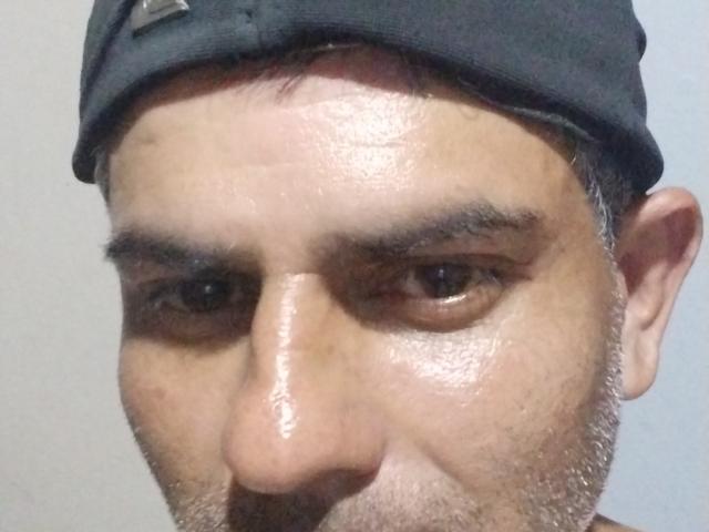 PetHot's face, a sweaty, bearded dude with dark eyebrows, brown eyes, and a black cap. His nose is prominent and his expression is serious.