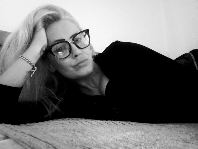 A flat, stylized illustration of a medieval-style coat of arms with a black, white, and red design. AlanRubia-hot is not visible. The coat of arms has a bold, geometric layout.