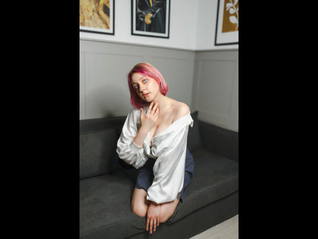 Flat, minimalist illustration of a coat of arms with a red and white emblem at the bottom. Simple, bold lines and colors. Madeline-Extasy's emblem is centered, with a clean, modern style.