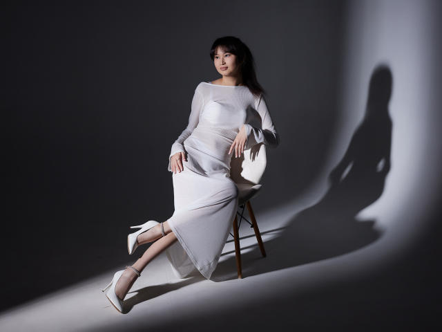 A flat, minimalist style illustration of five paper-like shapes, each with a small white cut-out design, arranged in a horizontal line. Simple color palette, muted tones. Clean, geometric composition.