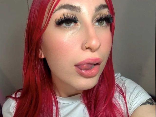 Digital illustration of a red banner with a white emblem in the center, featuring a stylized, bold design. The emblem is slightly raised, creating a three-dimensional effect.