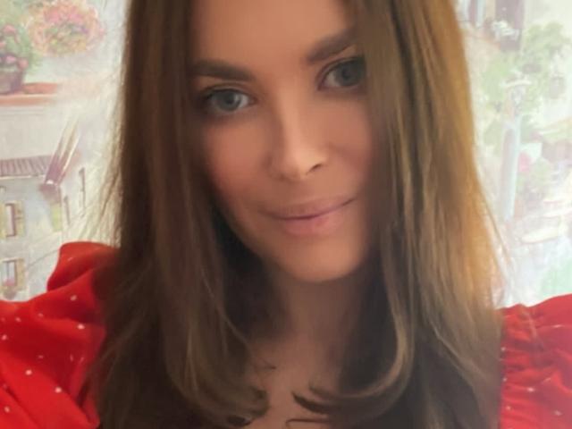AlicexFresh has brown, straight hair, blue eyes, and a slight smile. She's wearing a red shirt with white dots, looking cute and sexy.